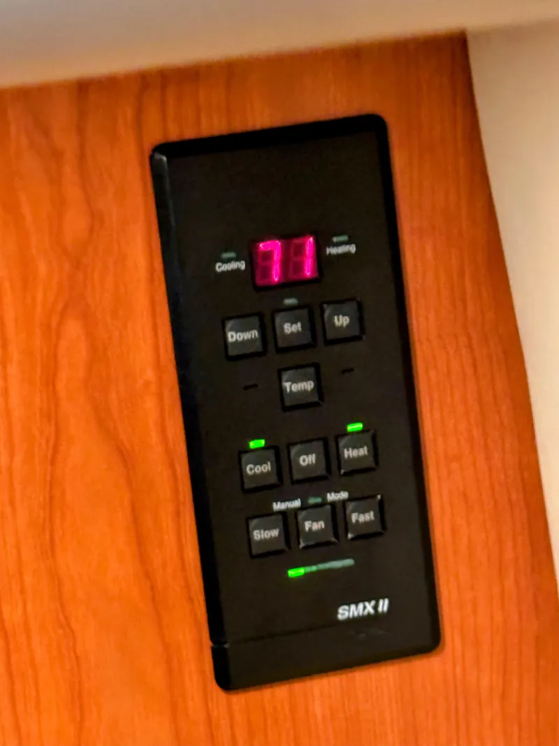 Slide: The Image of Control panel on 2001 Sea Ray 400 Sedan Bridge, displaying temperature settings. - 49