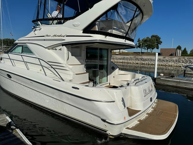 Slide: The Image of 2001 Sea Ray 400 Sedan Bridge yacht docked at marina, sunny day. - 7