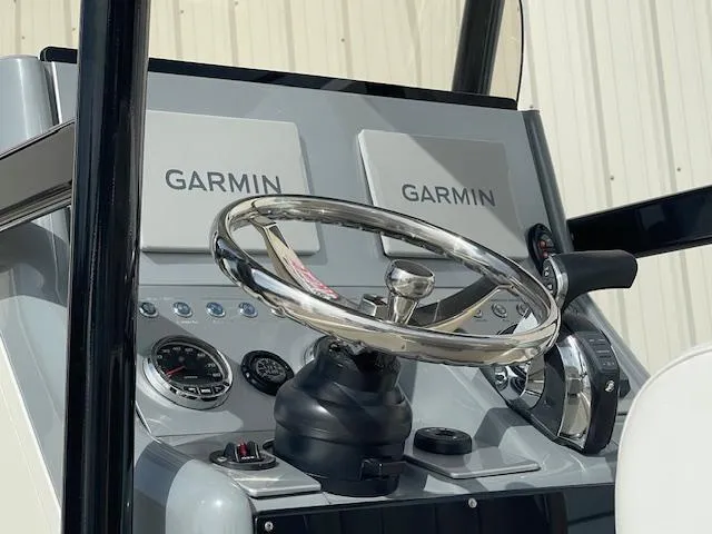 Slide: The Image of Steering console of 2022 ShearWater 25 boat with Garmin displays. - 10