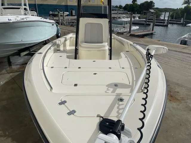 Slide: The Image of 2022 ShearWater 25 boat docked, showcasing spacious deck and sleek design. - 12