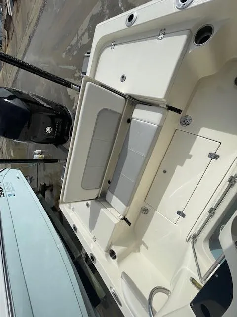 Slide: The Image of 2022 ShearWater 25 boat interior with seating and storage compartments. - 13