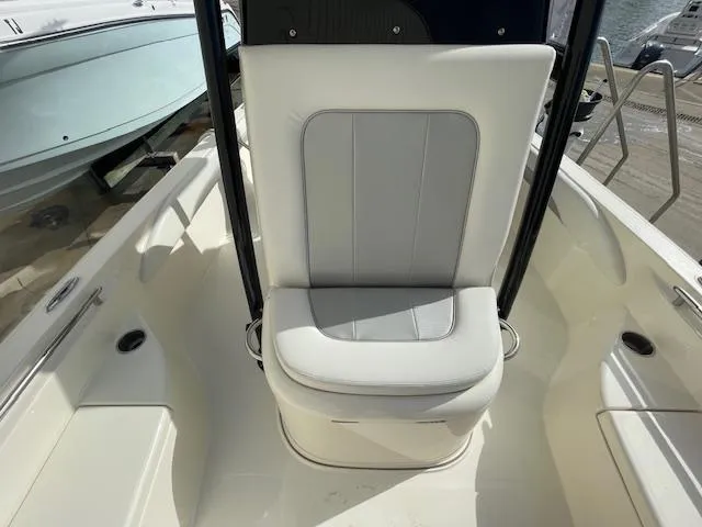 Slide: The Image of 2022 ShearWater 25 boat seat, white and gray upholstery, docked at marina. - 5