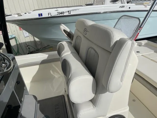 Slide: The Image of 2022 ShearWater 25 boat interior with white seating and console. - 7