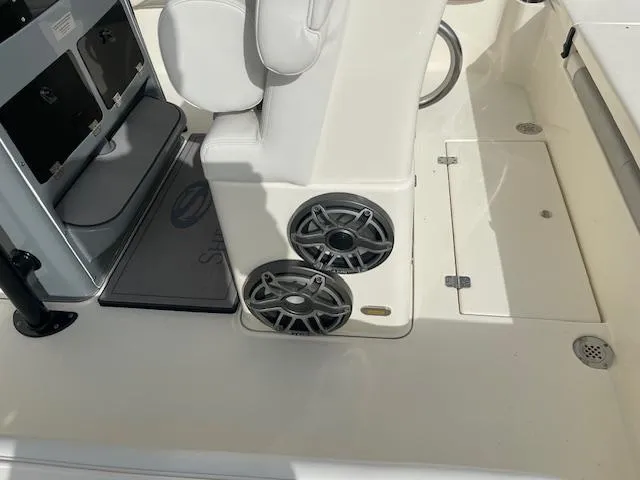 Slide: The Image of 2022 ShearWater 25 boat interior with speakers and seating area. - 8