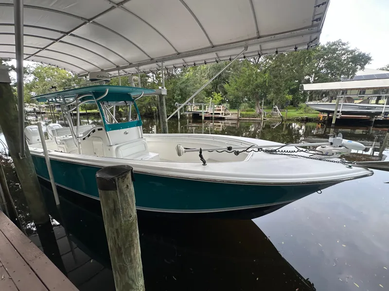 Slide: The Image of 2008 Palmetto 33 boat docked under canopy, calm water, lush greenery. - 16