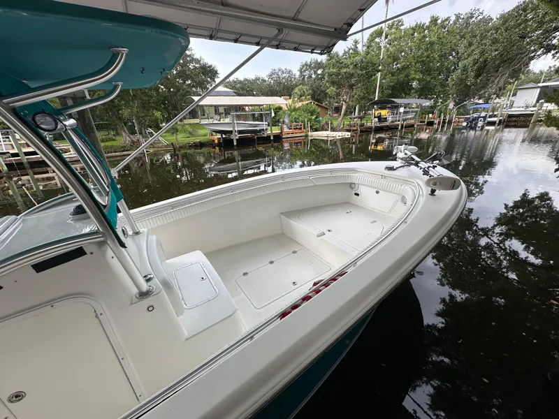 Slide: The Image of 2008 Palmetto 33 boat docked on a calm river under a canopy. - 17