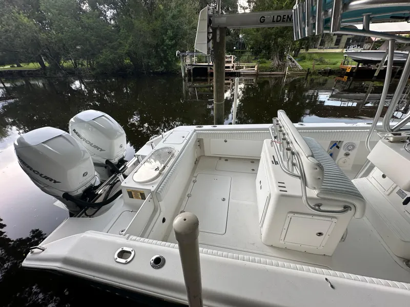 Slide: The Image of 2008 Palmetto 33 boat with dual Mercury engines docked by a river. - 20