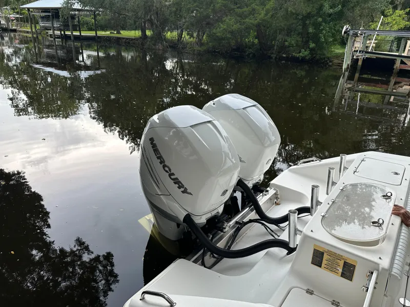 Slide: The Image of 2008 Palmetto 33 boat with twin Mercury outboard engines on a calm river. - 21
