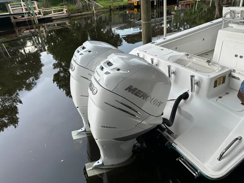 Slide: The Image of 2008 Palmetto 33 boat with twin Mercury outboard engines docked on calm water. - 22