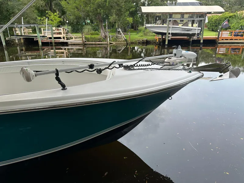 Slide: The Image of 2008 Palmetto 33 boat docked on a calm river with lush greenery. - 27