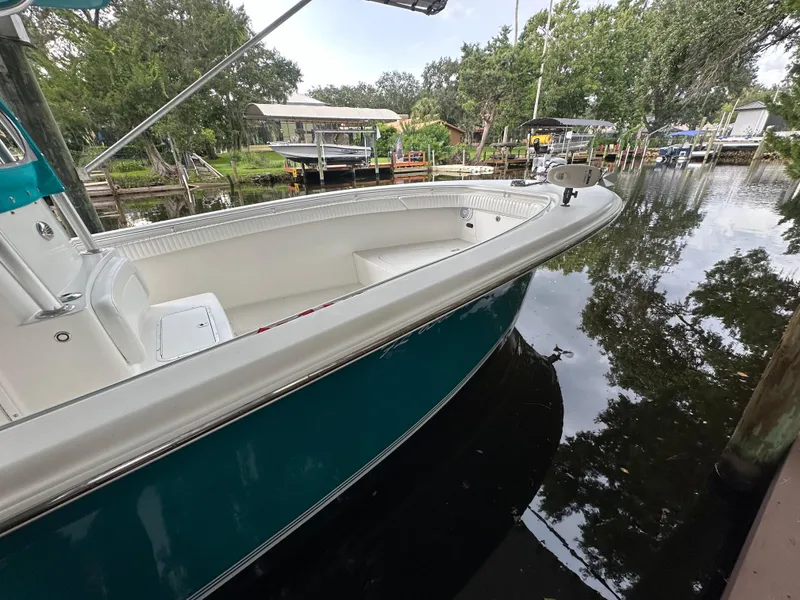 Slide: The Image of 2008 Palmetto 33 boat docked on a calm river with lush greenery. - 28