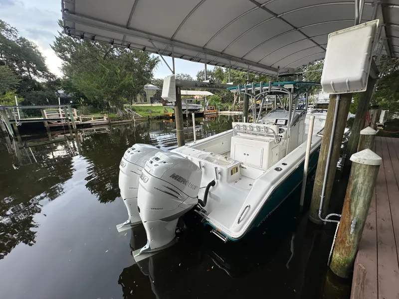 Slide: The Image of 2008 Palmetto 33 boat docked under canopy with twin outboard motors. - 30