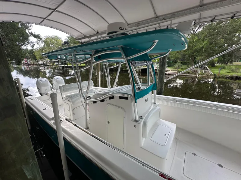 Slide: The Image of 2008 Palmetto 33 boat with canopy docked by a serene riverside. - 31