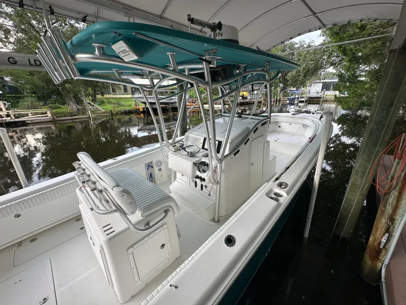 Slide: The Image of 2008 Palmetto 33 boat docked under canopy, featuring sleek design and spacious deck. - 32