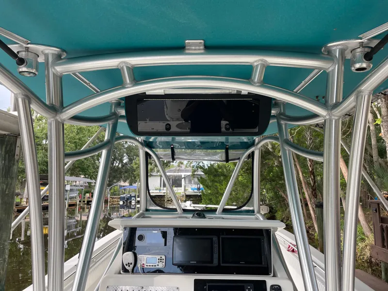 Slide: The Image of 2008 Palmetto 33 boat interior with navigation equipment and teal canopy. - 33