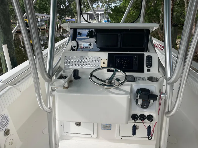 Slide: The Image of 2008 Palmetto 33 boat cockpit with steering wheel and control panel. - 34