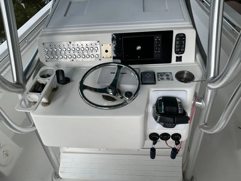 Slide: The Image of 2008 Palmetto 33 boat dashboard with steering wheel and control panel. - 36