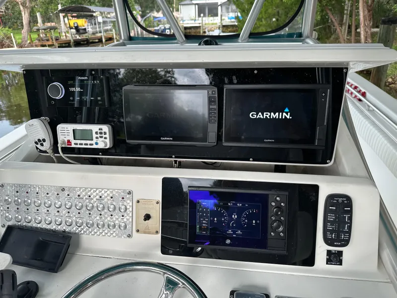 Slide: The Image of Control panel of a 2008 Palmetto 33 boat with Garmin navigation displays. - 40