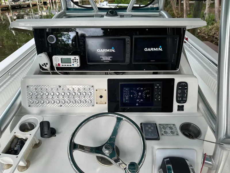 Slide: The Image of 2008 Palmetto 33 boat dashboard with Garmin navigation systems and steering wheel. - 41