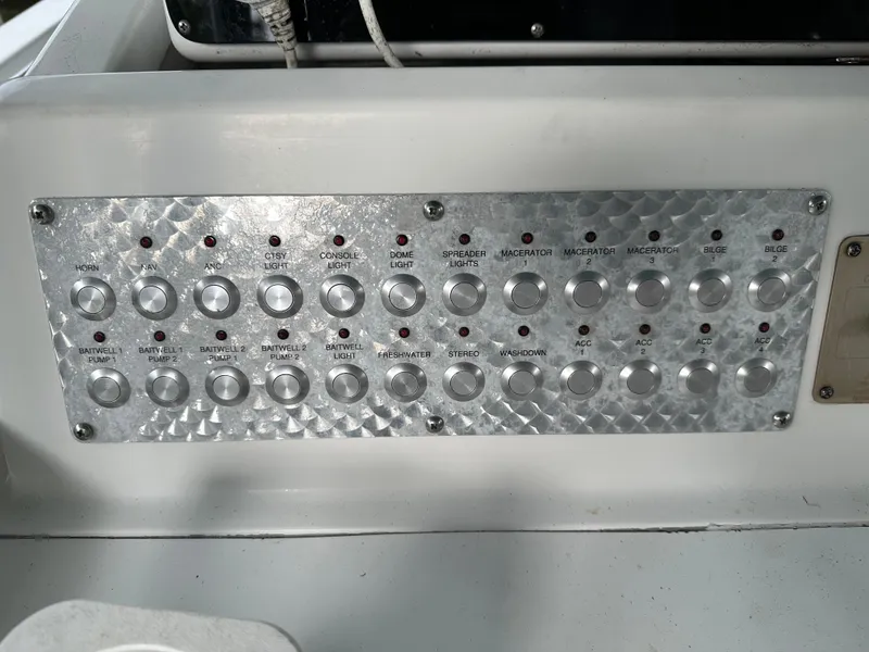 Slide: The Image of Control panel of a 2008 Palmetto 33 boat with labeled switches and buttons. - 42