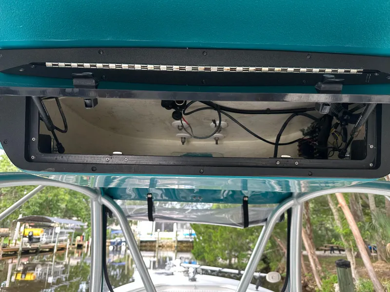 Slide: The Image of Open electronics compartment on 2008 Palmetto 33 boat, showing wiring and components. - 46