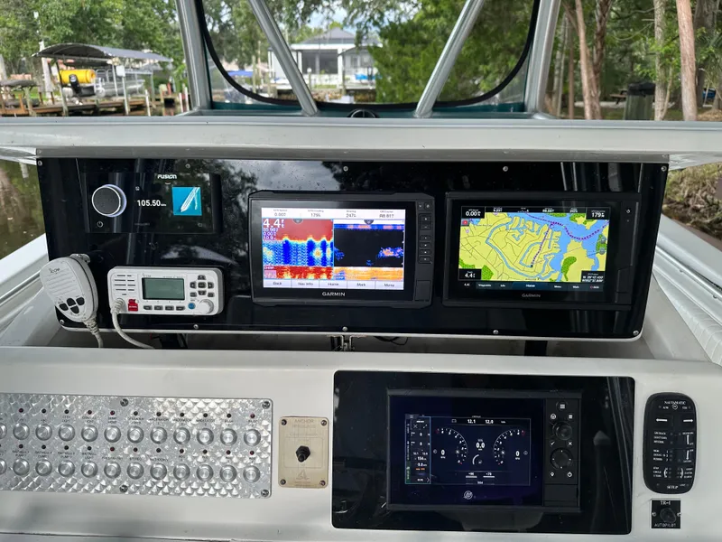Slide: The Image of 2008 Palmetto 33 boat dashboard with navigation and communication equipment. - 47
