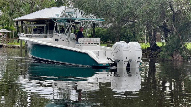 Slide: The Image of 2008 Palmetto 33 boat with dual engines on a calm river. - 5