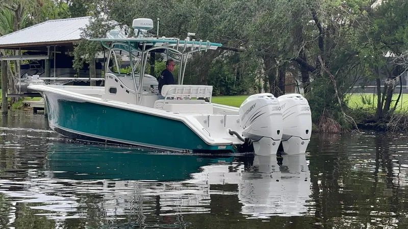 Slide: The Image of 2008 Palmetto 33 boat with dual engines on a calm waterway. - 8