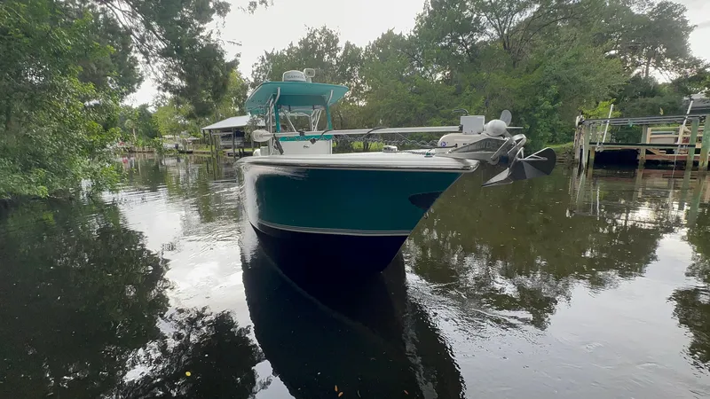 Slide: The Image of 2008 Palmetto 33 boat docked on a serene, tree-lined waterway. - 9