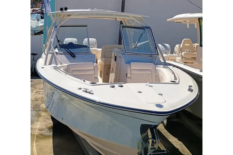 Slide: The Image of 2025 Grady-White Freedom 307 boat, sleek design, dual console, spacious seating, outdoor setting. - 1