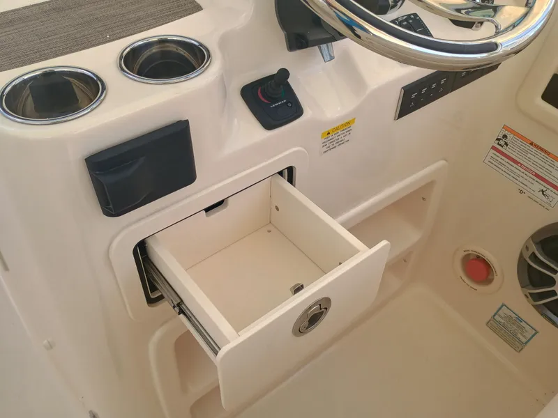 Slide: The Image of 2025 Grady-White Freedom 307 boat console with open storage drawer and cup holders. - 12