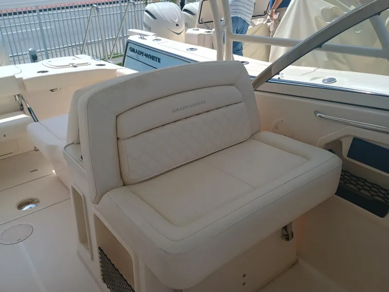 Slide: The Image of 2025 Grady-White Freedom 307 boat interior with beige seating and sleek design. - 14