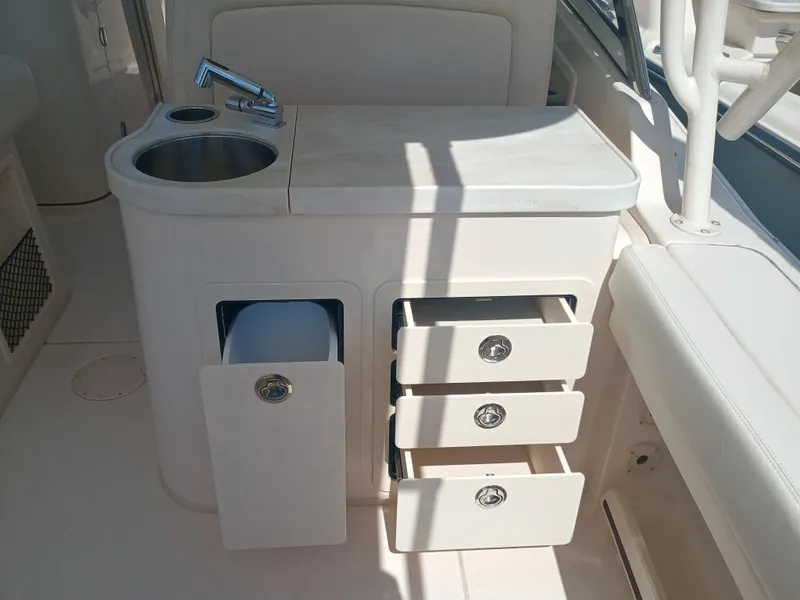Slide: The Image of 2025 Grady-White Freedom 307 boat interior with sink and storage drawers. - 15
