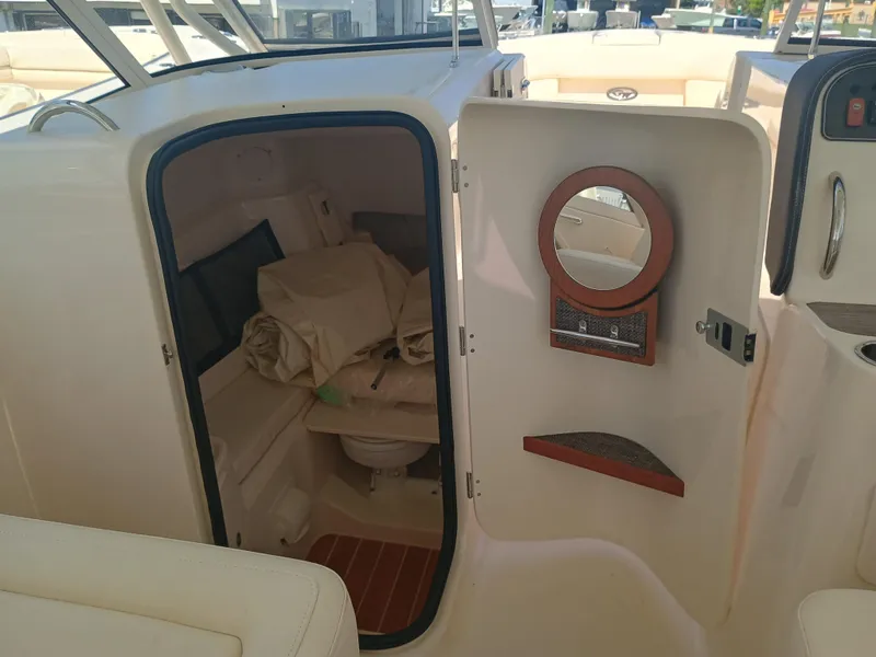 Slide: The Image of 2025 Grady-White Freedom 307 boat cabin interior with open door and mirror. - 18