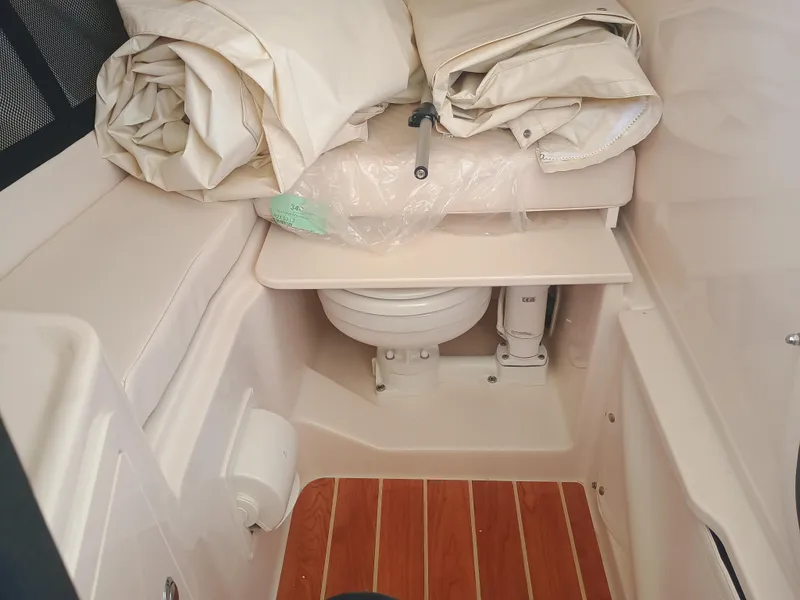 Slide: The Image of 2025 Grady-White Freedom 307 boat interior with toilet and folded canvas. - 21