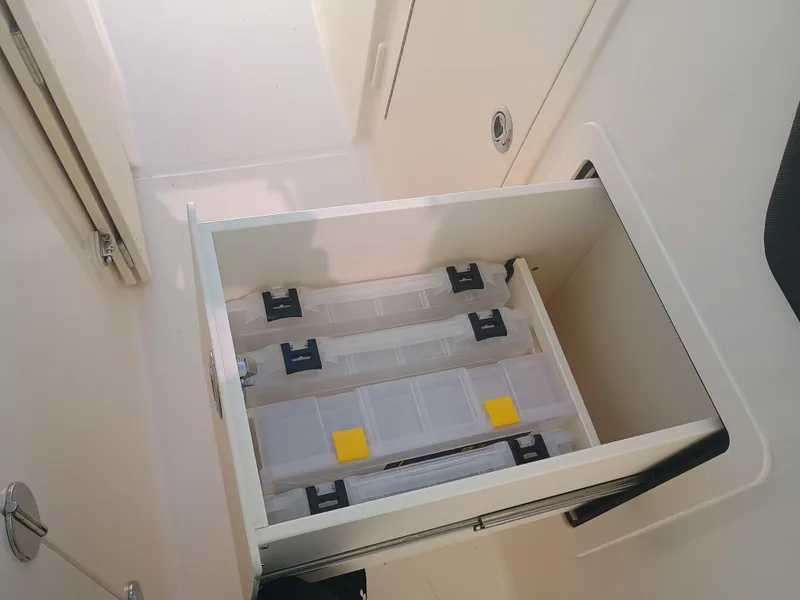 Slide: The Image of Storage compartment with tackle boxes on a 2025 Grady-White Freedom 307 boat. - 23