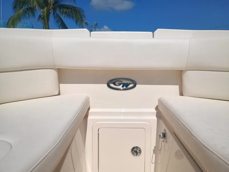 Slide: The Image of 2025 Grady-White Freedom 307 boat interior with logo, under clear blue sky. - 24