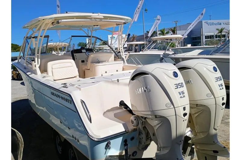 Slide: The Image of 2025 Grady-White Freedom 307 boat with twin Yamaha 350 V6 engines, docked outdoors. - 4