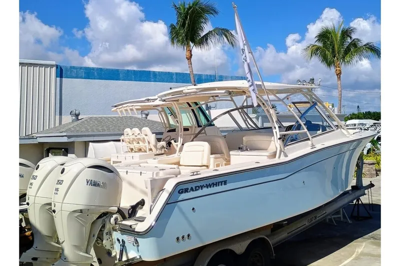 Slide: The Image of 2025 Grady-White Freedom 307 boat with Yamaha engines, docked under clear skies. - 5
