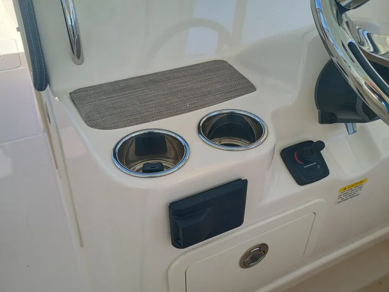 Slide: The Image of 2025 Grady-White Freedom 307 boat console with cup holders and steering wheel. - 8