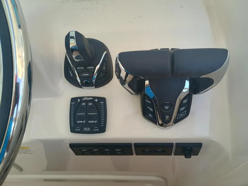 Slide: The Image of Control panel of 2025 Grady-White Freedom 307 boat with joystick and throttle controls. - 9