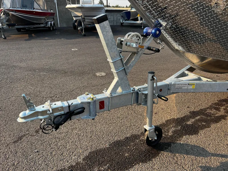 Slide: The Image of Trailer hitch of 2025 Fish Rite Angler 18 boat in a parking lot. - 16