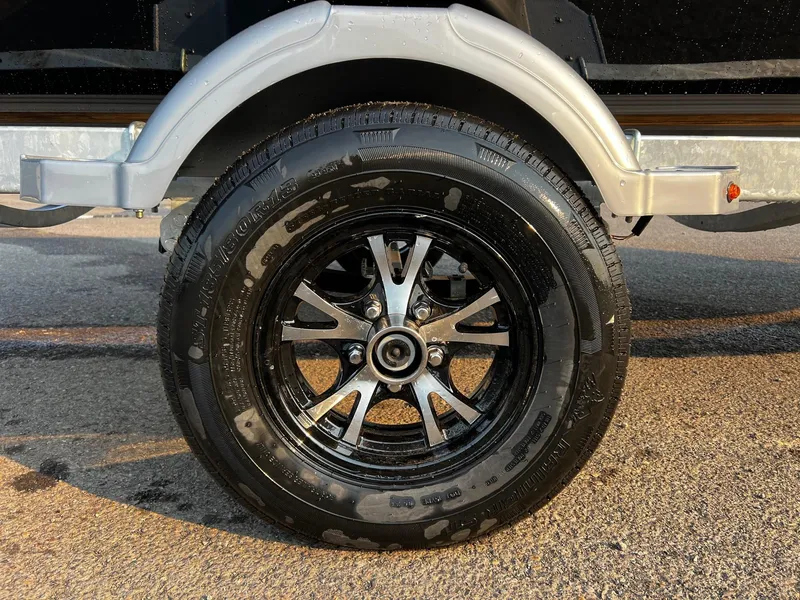 Slide: The Image of 2025 Fish Rite Angler 18 trailer wheel with black alloy rim and tire. - 17