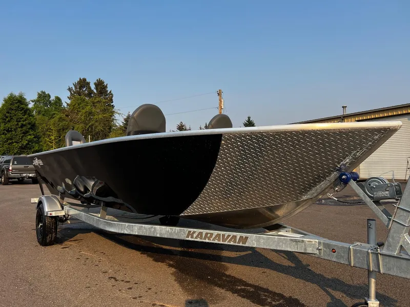 Slide: The Image of 2025 Fish Rite Angler 18 boat on Karavan trailer, parked outdoors. - 3
