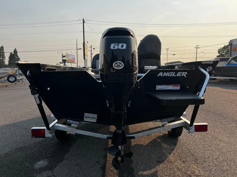 Slide: The Image of 2025 Fish Rite Angler 18 boat with 60 HP engine, rear view in parking lot. - 7
