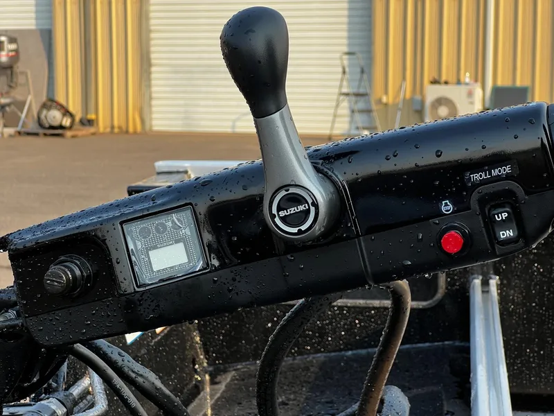 Slide: The Image of Close-up of 2025 Fish Rite Angler 18 boat control panel with Suzuki throttle. - 9