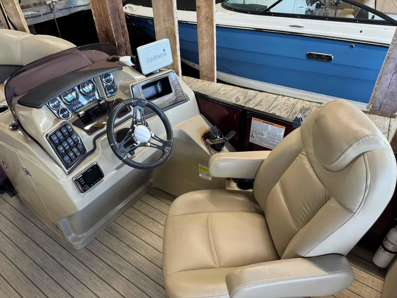 Slide: The Image of 2019 Starcraft SLS 3 boat cockpit with Garmin navigation system and beige captain's chair. - 4
