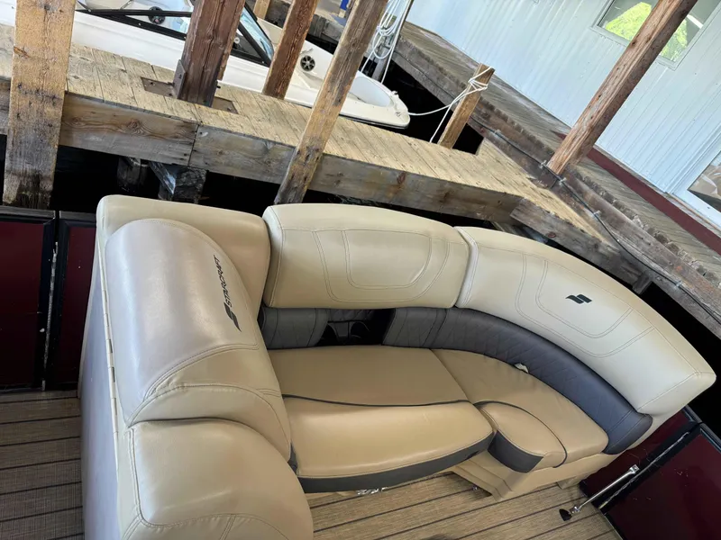 Slide: The Image of 2019 Starcraft SLS 3 boat interior with beige seating at a dock. - 7