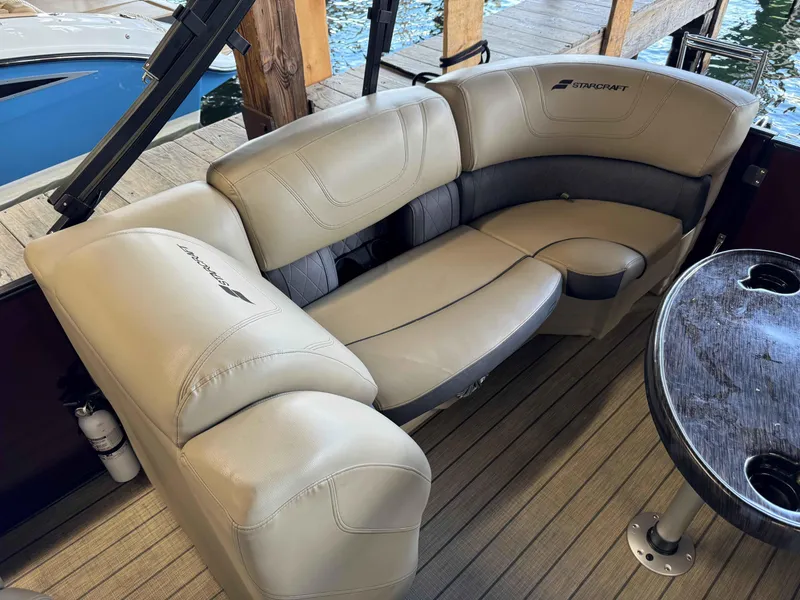 Slide: The Image of 2019 Starcraft SLS 3 boat interior with beige seating and wooden table. - 8