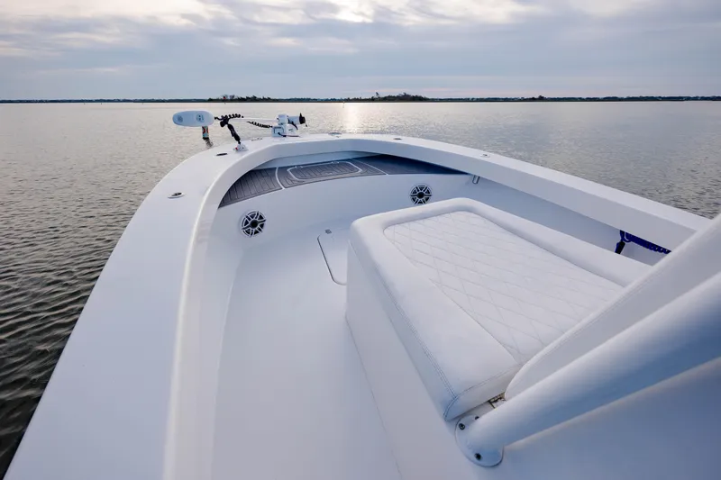 Slide: The Image of 2021 ZCB 26 Freemason boat on calm water, featuring sleek white design and spacious deck. - 20
